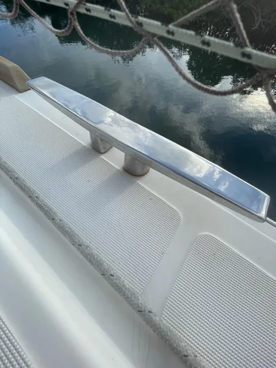 Matilda Mia Yacht Photos Pics Stainless steel cleat on 2015 Lagoon 52 yacht, reflecting sky and water.