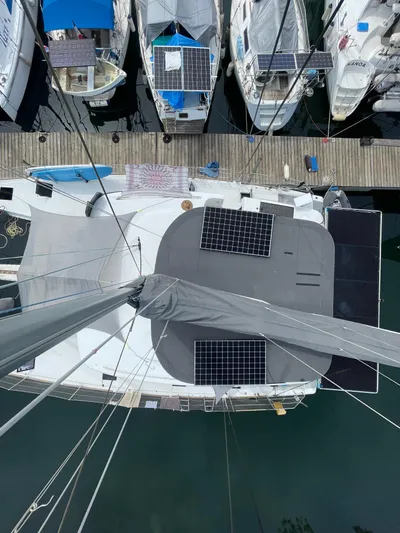 Matilda Mia Yacht Photos Pics Aerial view of a 2015 Lagoon 52 catamaran with solar panels docked at a marina.