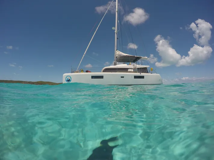 Matilda Mia Yacht Photos Pics 2015 Lagoon 52 catamaran sailing in clear turquoise waters under a blue sky.