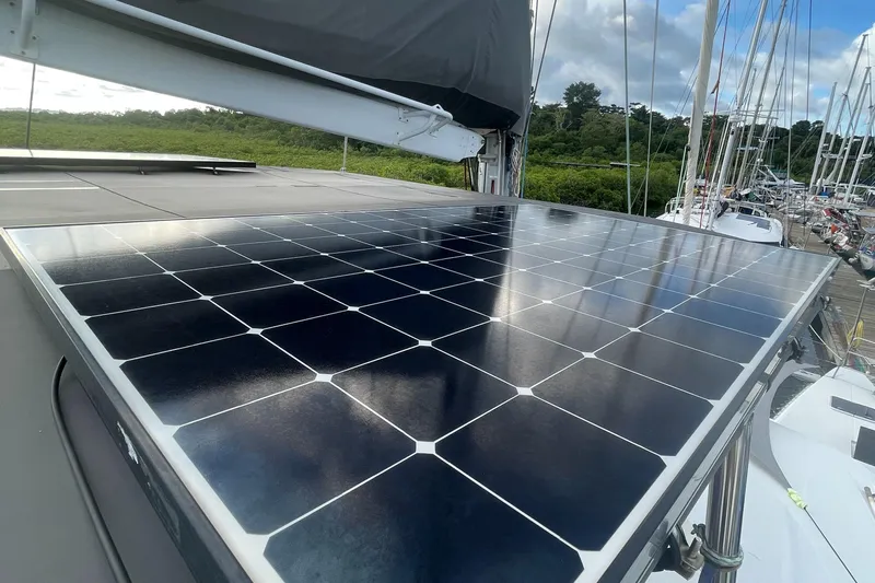 Matilda Mia Yacht Photos Pics Solar panel on 2015 Lagoon 52 yacht, docked with lush greenery in the background.