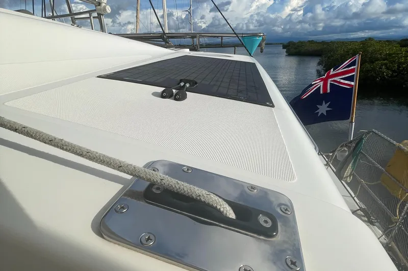 Matilda Mia Yacht Photos Pics Lagoon 52 catamaran deck with Australian flag, 2015 model, docked near lush greenery.