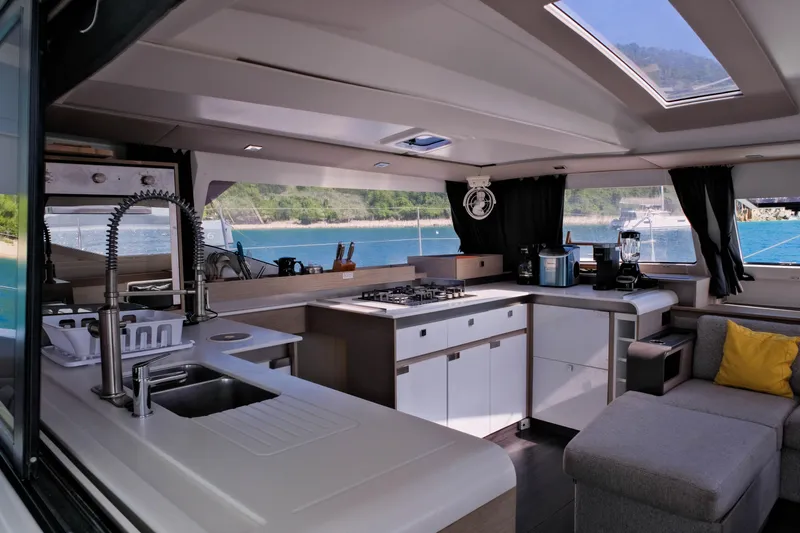 Ruckus Yacht Photos Pics Modern kitchen interior of 2021 Fountaine Pajot Elba 45 Catamaran with ocean view.