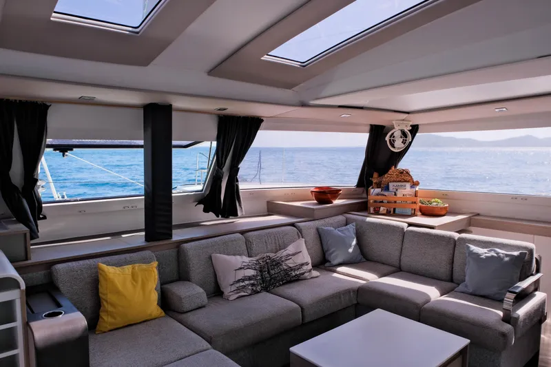 Ruckus Yacht Photos Pics Luxurious interior of 2021 Fountaine Pajot Elba 45 Catamaran with ocean view.