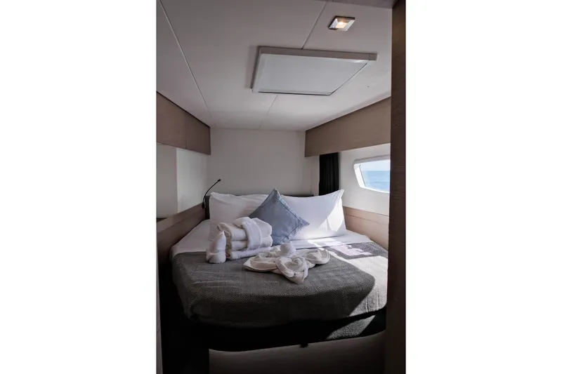 Ruckus Yacht Photos Pics Luxurious cabin interior of 2021 Fountaine Pajot Elba 45 Catamaran with cozy bedding.