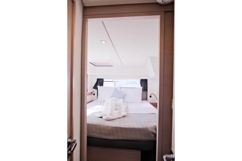 Ruckus Yacht Photos Pics Interior view of 2021 Fountaine Pajot Elba 45 Catamaran bedroom with neatly arranged bed.