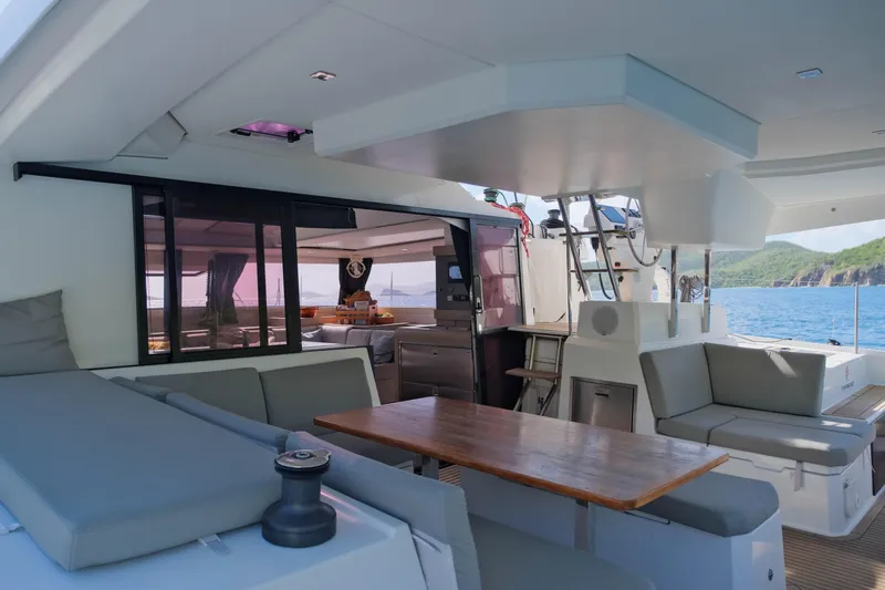 Ruckus Yacht Photos Pics Luxurious 2021 Fountaine Pajot Elba 45 Catamaran interior with seating and ocean view.