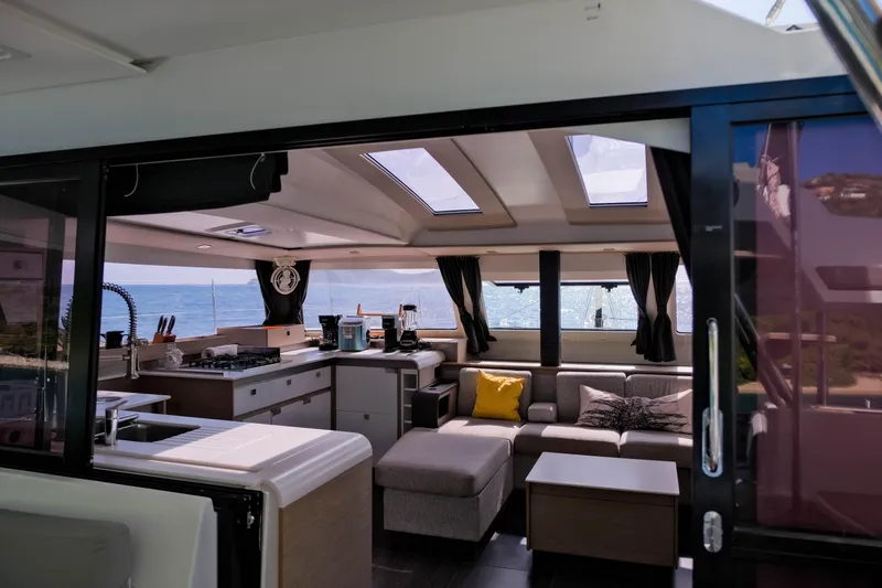 Ruckus Yacht Photos Pics Luxurious interior of 2021 Fountaine Pajot Elba 45 Catamaran with ocean view.