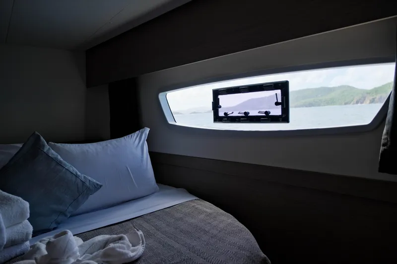 Ruckus Yacht Photos Pics Cozy cabin interior of 2021 Fountaine Pajot Elba 45 Catamaran with ocean view.