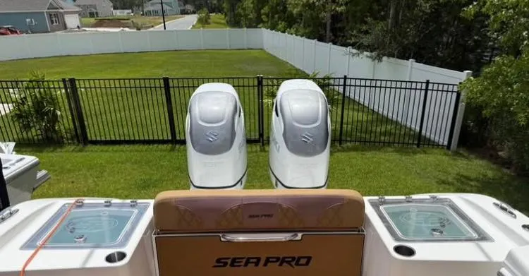  Yacht Photos Pics 2022 Sea Pro 320 DLX Offshore boat with dual engines, parked in a grassy yard.