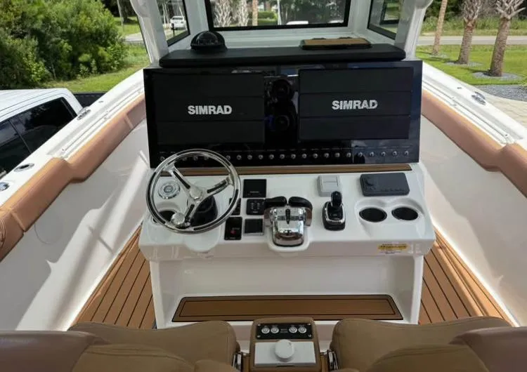  Yacht Photos Pics 2022 Sea Pro 320 DLX Offshore helm with Simrad displays and modern controls.