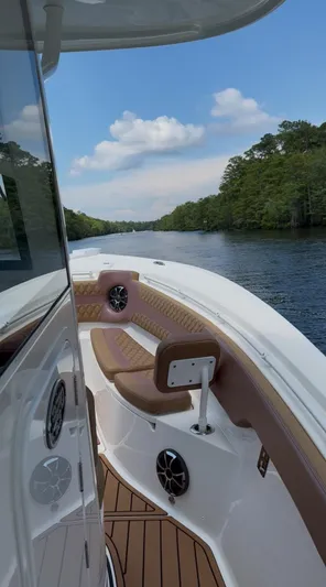  Yacht Photos Pics 2022 Sea Pro 320 DLX Offshore boat cruising on a scenic river with lush greenery.