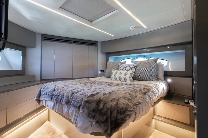 Plastered Yacht Photos Pics Luxurious bedroom interior of 2016 Pershing 62 yacht with modern design and cozy bedding.