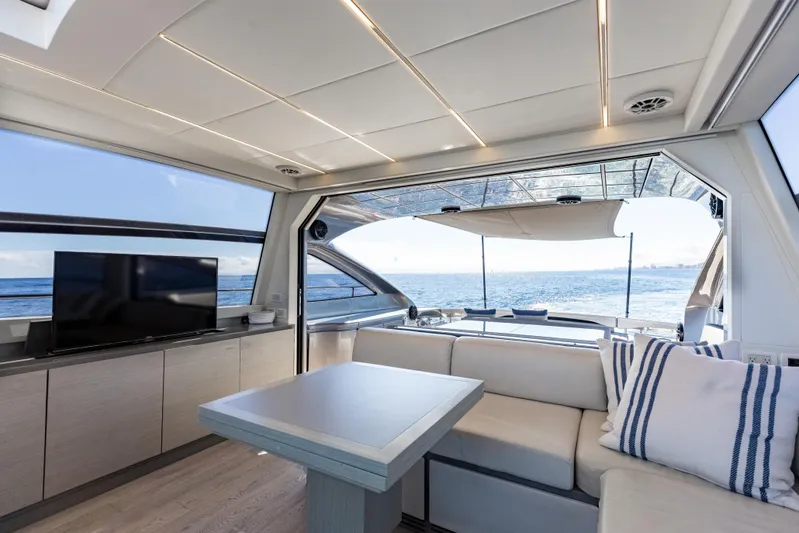 Plastered Yacht Photos Pics Luxurious interior of 2016 Pershing 62 yacht with ocean view and modern amenities.