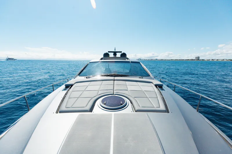 Plastered Yacht Photos Pics 2016 Pershing 62 yacht cruising on open sea under clear blue sky.