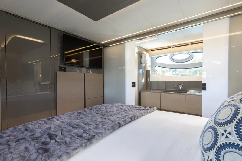 Plastered Yacht Photos Pics Luxurious interior of 2016 Pershing 62 yacht with modern bedroom and ensuite bathroom.