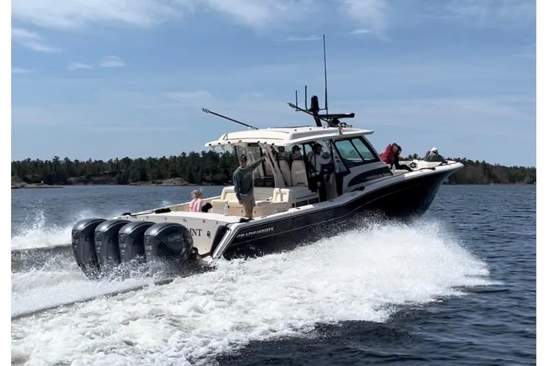  Yacht Photos Pics 2023 Grady-White Canyon 456 boat cruising on a lake with four engines.