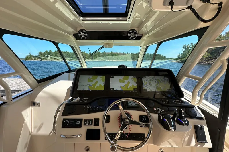  Yacht Photos Pics Interior view of 2023 Grady-White Canyon 456 boat cockpit with navigation screens.