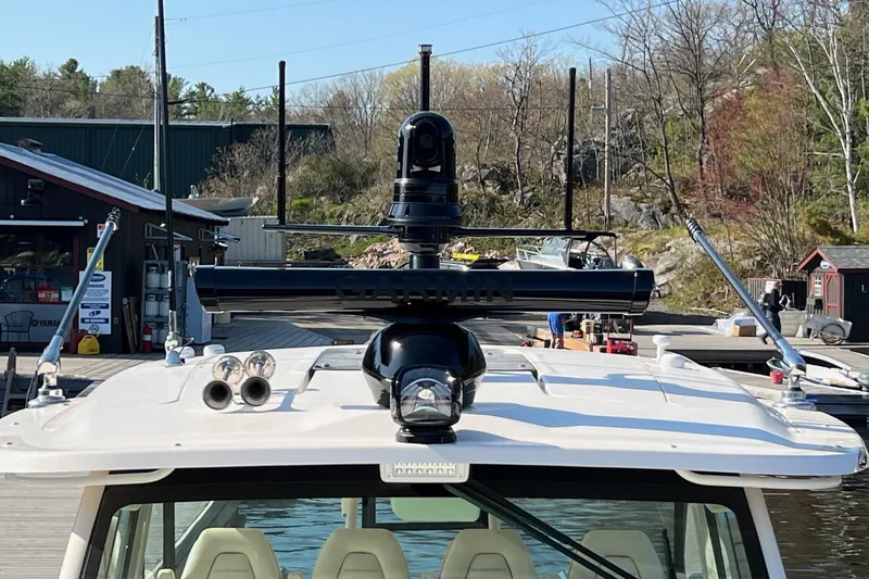  Yacht Photos Pics 2023 Grady-White Canyon 456 boat with advanced radar equipment at a dock.