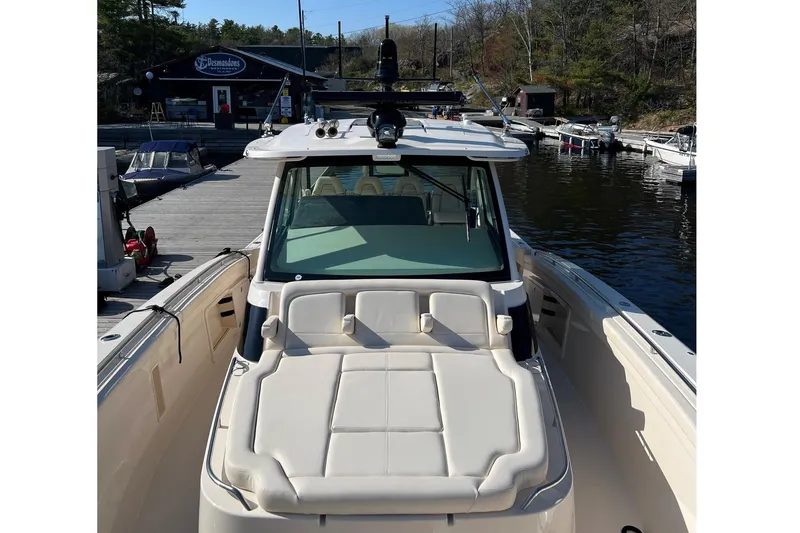  Yacht Photos Pics 2023 Grady-White Canyon 456 boat docked at marina, showcasing spacious seating.