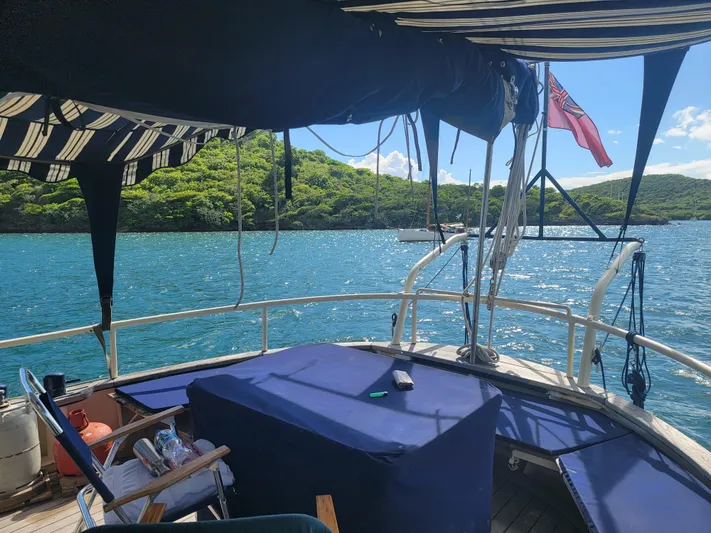 Maisie Rose Yacht Photos Pics View from 1984 Custom Kuipper NV Holland boat, overlooking serene blue waters and lush greenery.