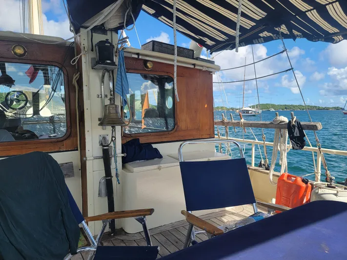 Maisie Rose Yacht Photos Pics Sailboat deck with seating, Custom Kuipper NV Holland, 1984, on a sunny day at sea.