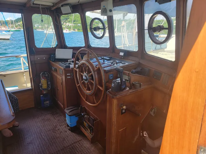 Maisie Rose Yacht Photos Pics Vintage 1984 Kuipper NV Holland boat interior with wooden helm and nautical instruments.