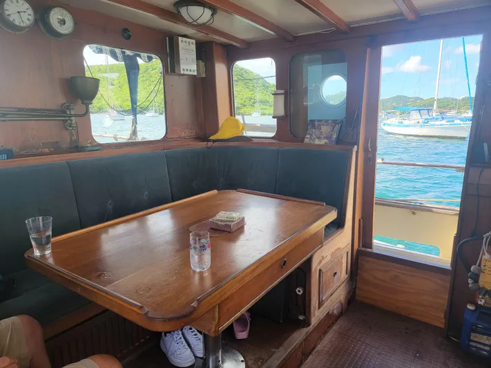 Maisie Rose Yacht Photos Pics Interior of 1984 Kuipper NV Holland boat with wooden table and scenic window view.