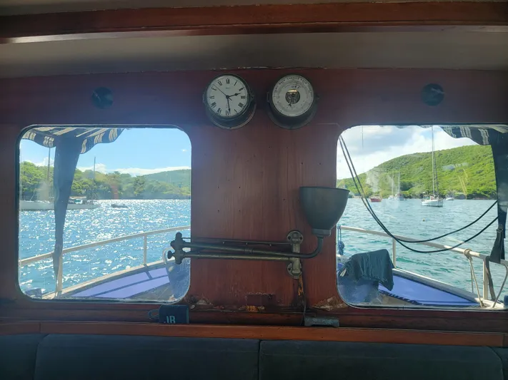 Maisie Rose Yacht Photos Pics View from inside 1984 Kuipper NV Holland boat, overlooking scenic water and lush hills.
