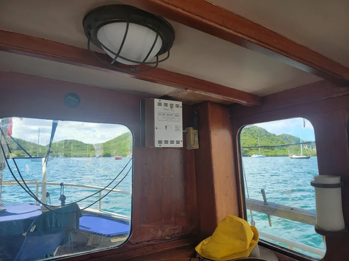 Maisie Rose Yacht Photos Pics Interior view of 1984 Kuipper NV Holland boat with scenic ocean and mountain backdrop.