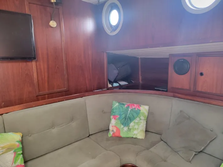 Maisie Rose Yacht Photos Pics Cozy 1984 Kuipper NV Holland boat interior with wood paneling and cushioned seating.