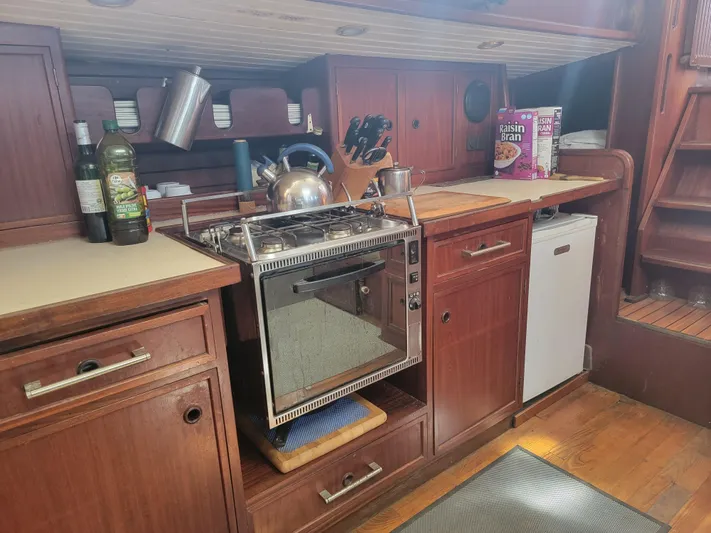Maisie Rose Yacht Photos Pics Vintage 1984 Kuipper NV Holland yacht kitchen with wooden cabinets and stove.