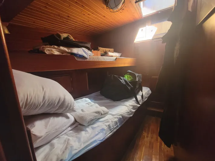 Maisie Rose Yacht Photos Pics Cozy wooden cabin interior on 1984 Kuipper NV Holland boat with bunk beds.