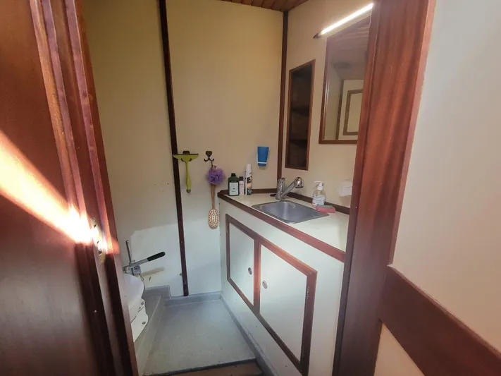 Maisie Rose Yacht Photos Pics Compact 1984 Kuipper NV Holland bathroom with sink, mirror, and wooden accents.