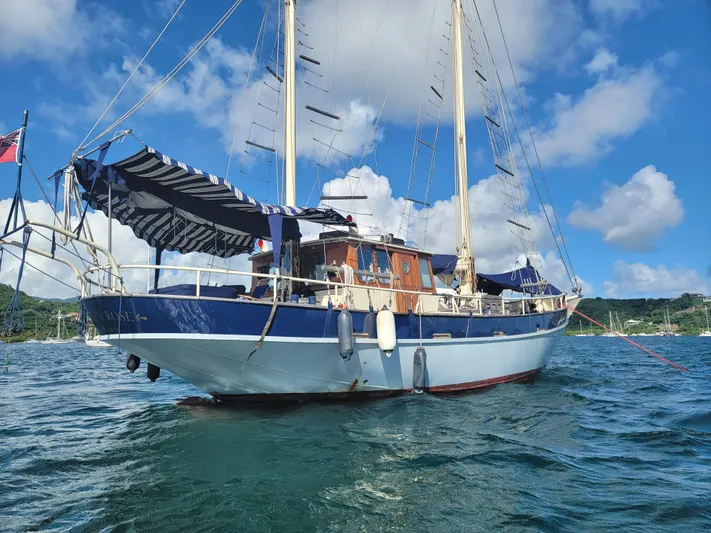 Maisie Rose Yacht Photos Pics Vintage 1984 Kuipper NV Holland sailboat on water, blue sky background.