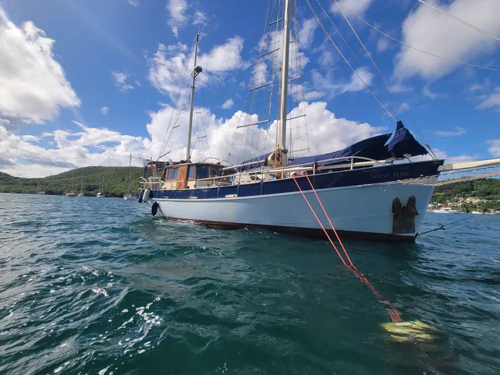 Maisie Rose Yacht Photos Pics Sailing yacht "Kuipper NV Holland" 1984 on calm waters under a blue sky.