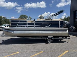 2021 Godfrey SW 2086 C pontoon boat on trailer, parked outdoors under blue sky.