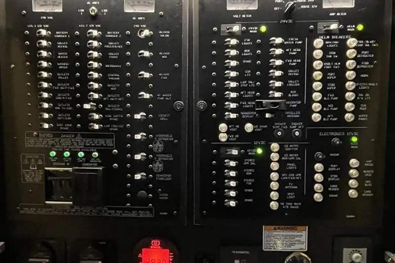Simply Complicated Yacht Photos Pics Electrical control panel of 2019 Cruisers Yachts 54 Cantius, featuring switches and indicators.