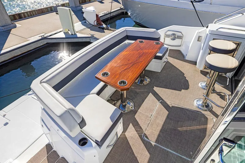 Simply Complicated Yacht Photos Pics 2019 Cruisers Yachts 54 Cantius deck with seating and wooden table.
