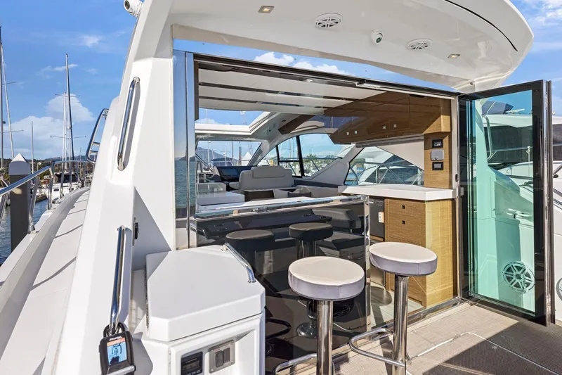 Simply Complicated Yacht Photos Pics 2019 Cruisers Yachts 54 Cantius luxury yacht interior with bar stools and modern design.