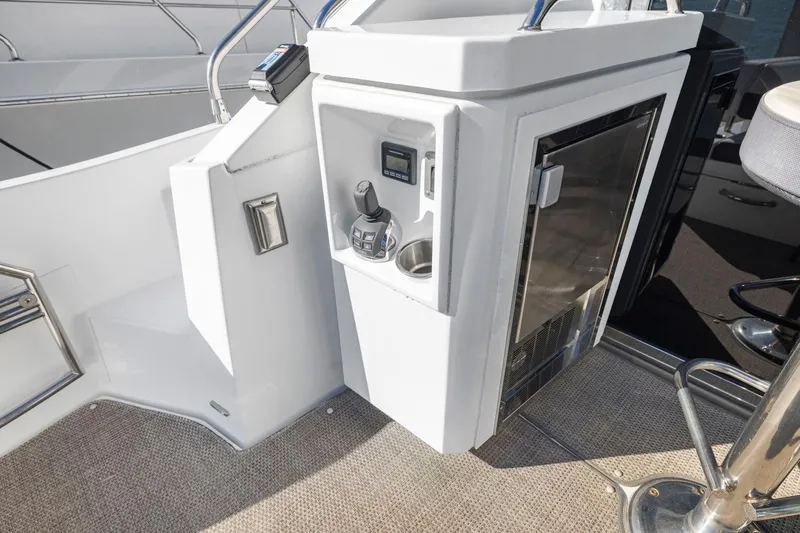 Simply Complicated Yacht Photos Pics 2019 Cruisers Yachts 54 Cantius cockpit with control panel and seating area.