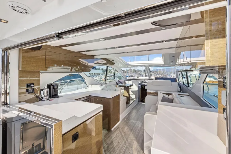Simply Complicated Yacht Photos Pics Luxurious interior of 2019 Cruisers Yachts 54 Cantius with modern design and marina view.