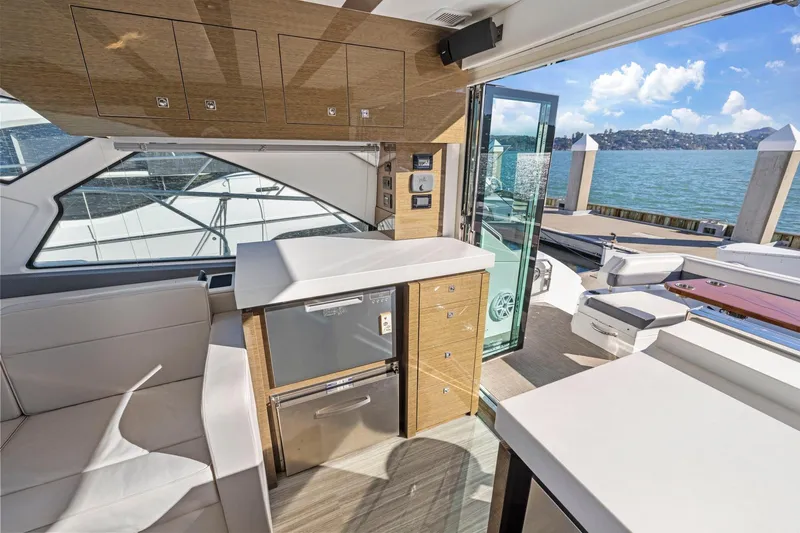 Simply Complicated Yacht Photos Pics Luxurious interior of 2019 Cruisers Yachts 54 Cantius with modern amenities and scenic water view.
