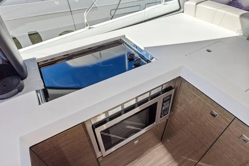 Simply Complicated Yacht Photos Pics Modern kitchen area on 2019 Cruisers Yachts 54 Cantius with stove and microwave.