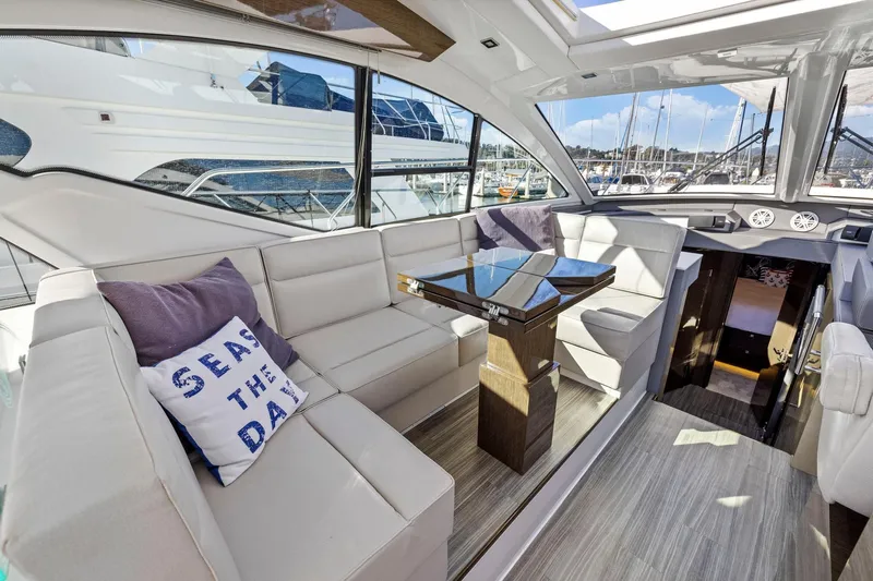 Simply Complicated Yacht Photos Pics Luxurious interior of 2019 Cruisers Yachts 54 Cantius with elegant seating and table.