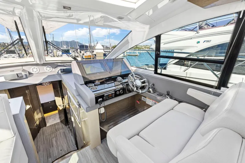 Simply Complicated Yacht Photos Pics Luxurious 2019 Cruisers Yachts 54 Cantius helm with modern controls and plush seating.