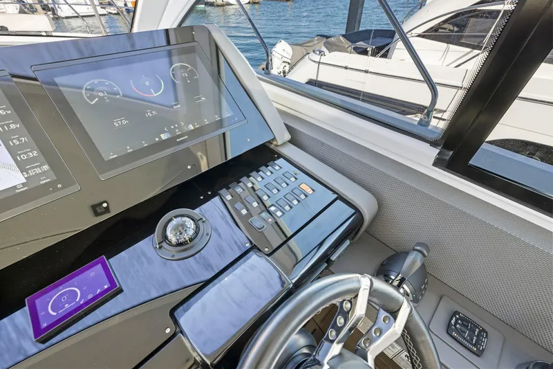 Simply Complicated Yacht Photos Pics 2019 Cruisers Yachts 54 Cantius helm with modern navigation displays and controls.