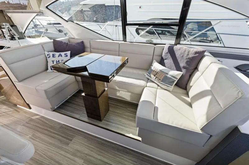 Simply Complicated Yacht Photos Pics Luxurious 2019 Cruisers Yachts 54 Cantius interior with plush seating and elegant table.