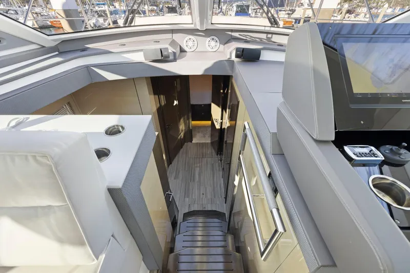Simply Complicated Yacht Photos Pics Interior view of 2019 Cruisers Yachts 54 Cantius, showcasing modern design and navigation equipment.