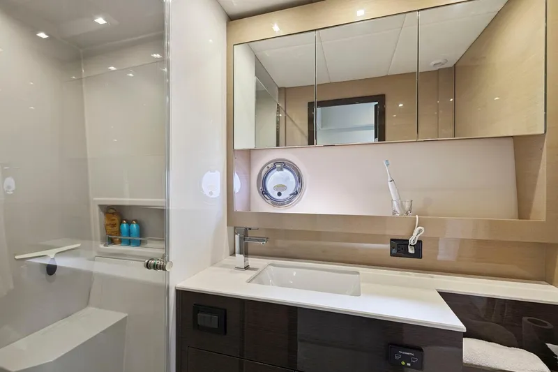 Simply Complicated Yacht Photos Pics Luxurious bathroom in 2019 Cruisers Yachts 54 Cantius with modern fixtures and porthole window.