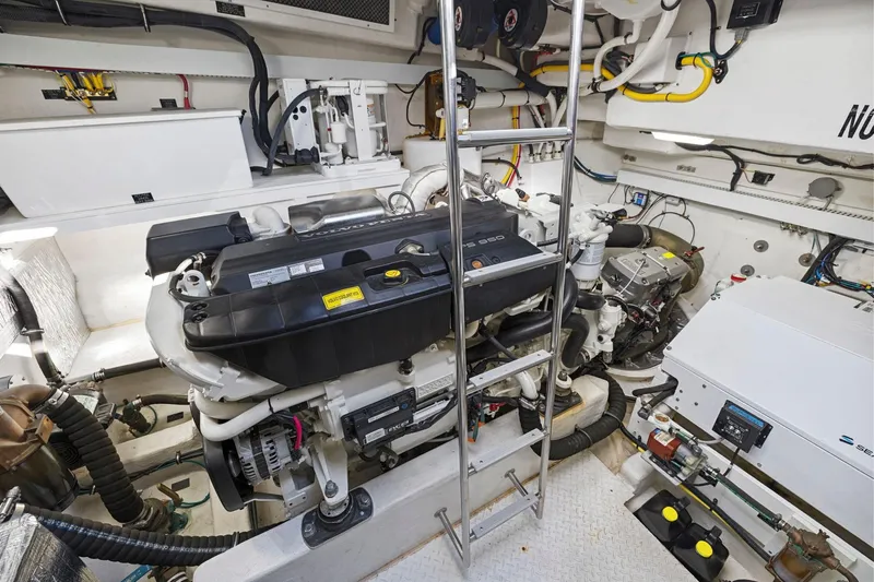 Simply Complicated Yacht Photos Pics Engine room of 2019 Cruisers Yachts 54 Cantius, featuring dual engines and equipment.